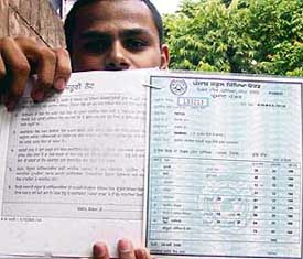 A student shows the detailed marks card without official stamp and any signature issued to him by the Punjab School Education Board in Mohali on Tuesday.