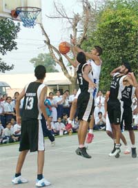 Gurkeerat Singh (man of the tournament) of BSF School, Jalandhar (white), tries to score a basket against MGN School (black) at the BSF campus during the CBSE Sahodaya Basketball Tournament in Jalandhar on Saturday. The BSF boys’ team won the tournament 65-42.