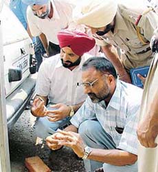 Forensic experts at Sudarshan Textiles Engineering Works after the robbery in Ludhiana