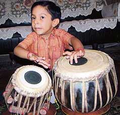 Five-year-old Agam Shingar, having his name in the Limca Book of World Records as the youngest classical tabla player, during a television show in Amritsar on Tuesday.