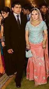 Pakistans wicketkeeper Kamran Akmal and his bride Aaiza Ilyas arrive to attend their wedding reception in Lahore