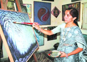 Mala Chawla gives finishing touches to one of her paintings at Amritsar