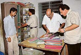 Officers of the UT Excise and Taxation Department go through the records during a raid at the Chandigarh Club