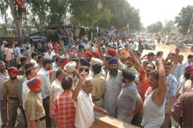 Owners of temporary vends on Garha Road hold protest after MC officials conducted a demolition drive on Wednesday.