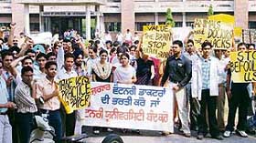 Students of Guru Angad Dev Veterinary and Animal Sciences University stage a demonstration in Ludhiana on Wednesday.