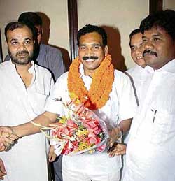 Jharkhand Chief Minister Madhu Koda accepts congratulations from Independent MLA Bandhu Tirkey after winning the trust vote in the Assembly in Ranchi on Wednesday. 