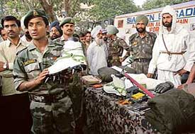 Members of the Siachen to Chandigarh motor-cycle expedition display equipment used by troopers at Siachen, the world's highest battlefield, in Chandigarh on Thursday
