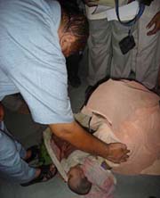 Ms Angoori Devi places the body of her grandson Rahel at the feet of Deputy Commissioner J.P. Kaushik at the mini secretariat, Jagadhri, on Thursday.