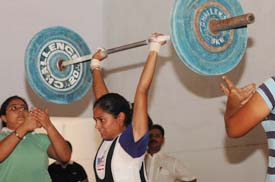 Rajbir of Hansraj Maha Vidalaya (HMV) in action during the 48kg category competitions at the District Jalandhar Open Womens Weightlifting  Championships held at BD Arya College for Women at Jalandhar Cantt on Thursday. Rajbir won the second position while Kusum of BD Arya College stood first in the category. BD Arya College won the overall championship. 