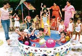 Tiny tots enjoy a pool party organised at SpringDale School, Ludhiana, on Thursday.