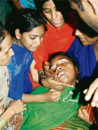 Mother of Asraf, who died in the police firing at Seelampur on Wednesday, is consoled by other women in East Delhi
