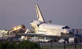 Technicians work on the space shuttle Atlantis after it landed at the Kennedy Space Center in Cape Canaveral, Florida, on Thursday.