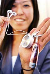 Japan's electronics giant Sony employee displays a new audio accessory for small audio players, a key-ring style headphone, which has an inner-ear headphone with a rewind case for Sony audio players/walkman series, in Tokyo on Friday.