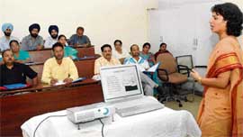 Dr Bhawna from the Government Medical College and Hospital, Sector 32, delivers a lecture to medical and para-medical workers in the first day of the cancer control programme organised at the Postgraduate Institute of Medical Education and Research, Chandigarh, on Friday.
