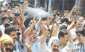 A group of traders taking out a Shav Yatra with a mock body representing the Delhi Government, in a novel way to protest against the sealing drive.