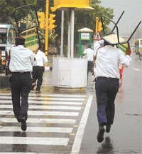 The sudden showers caught these traffic policemen by surprise as they rushed for