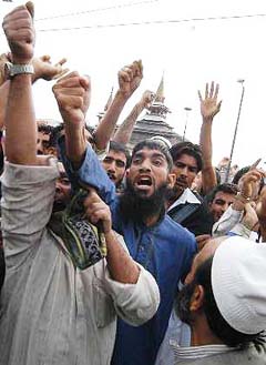 Protesters raise slogans in downtown Srinagar during a protest on Friday against comments by Pope Benedict on Islam