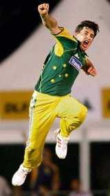 Brad Hogg of Australia celebrates the dismissal of Ajit Agarkar during the one-day match at the Kinrara Oval, Kuala Lumpur, on Friday