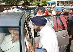 Mr Sukhbir Singh Badal talks to Mr Sukhdev Singh Dhindsa after submitting a memorandum against the Amarinder government to the Punjab Governor at Raj Bhavan in Chandigarh on Saturday. 