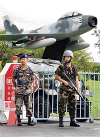Soldiers stand guard at Chiang Mai International Airport, 700 km north of Bangkok, on Saturday