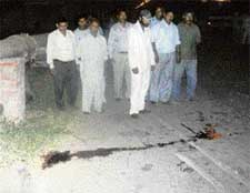 Passersby gather at the scene of the accident where three members of a Mohali Phase XI family were killed in a hit-and-run case on Sunday night