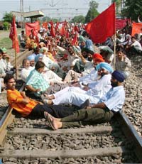 Farmers stage a dharna on the railway track in Dhandari Kalan village of Ludhiana on Sunday