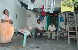 Babu Ram his wife and another relative sitting outside the only room left with them in the Shastri Badminton Hall premises