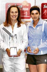 Martina Hingis of Switzerland and Sania Mirza pose with their trophies during the prize distribution ceremony at the Sunfeast Open in Kolkata on Sunday