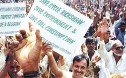 Rickshaw-pullers protest against the recent orders of the Delhi High Court and the Municipal Corporation of Delhi to ban rickshaws.
