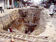 Deep trenches dug up for laying sewerage in the main market at Quadian