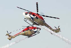 Two Dhruv helicopters cross each other closely as Sarang Display Team showcases its manoeuvres at the Air Force Station, Adampur, on Tuesday.