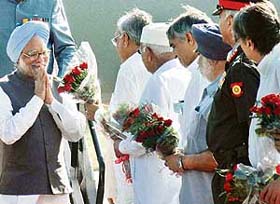 Prime Minister Dr Manmohan Singh is welcomed with flowers at the Chandigarh Air Force Station on Wednesday as senior functionaries queue up to greet him
