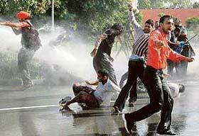 Policemen use water cannons to disperse members of the unemployed Pharmacists Union at the Matka Chowk in Chandigarh