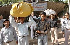 Visually challenged persons take away their belongings after calling off three-year-old agitation in Chandigarh on Wednesday.