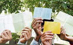 Labourers of a leading hosiery in Ludhiana show the attendance cards issued to them, which is the only proof of their employment in the unit. 