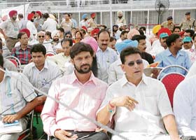 Shambu Prasad (pink shirt) sitting in VIP block adjacent to the press block in the Guru Nanak Stadium where the Prime Minister, Dr Manmohan Singh, inaugurated a series of projects in Ludhiana