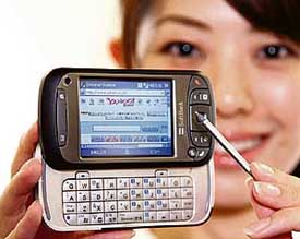 A model displays Softbank's smart phone "X01HT", produced by Taiwanese maker High-Tech Computer, equipped with a 400 MHz Samsung stuck CPU and featuring Microsoft's Windows Mobile 5.0, at a press preview in Tokyo on Thursday