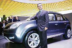 Renault CEO Carlos Ghosn poses in front of Koleos concept car at a preview of the Paris Motor Show on Thursday. The two-week show from September 30 to October 15 will see more than 65 new models given their world premiere. More than 1 million people attend the show each year. 