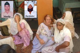 Family members of Mandip Singh and Harjinder Singh mourn at Raipur village in Jalandhar on Thursday