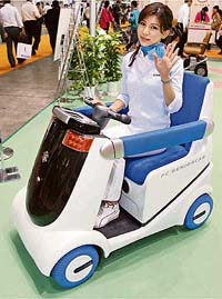 Japan's auto-maker Suzuki Motor unveils a prototype model of fuel cell-powered electric wheelchair "Senior car MIO" at the annual international homecare and rehabilitation exhibition in Tokyo on Friday.