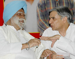 Mr Buta Singh, a former Union Minister, in conversation with Mr Pawan Kumar Bansal, Minister of State for Finance, at a meeting of safai karamcharis' unions in Chandigarh on Friday. 