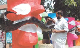 Evil Incarnated: A replica of Ravan, the mythological demon king, gets a final coat of paint before heading for a Ramlila ground, where it would be set afire on Dussehra on Monday a symbolic defeat of immorality.