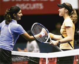Sania Mirza (left) was overwhelmed by Martina Hingis in the Sunfeast Open, but she made amends by winning the womens doubles title with Liezel Huber.