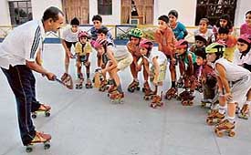 Roller skating coach Chander (extreme left) gives tips to budding skaters at Dikshant Skating Rink, Zirakpur. 