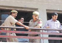 Policemen at the residence of Sandeep Jain, accused of forcefully confining his sister at home for the last two years along with his brother to prevent her from marrying a person of another caste. 
