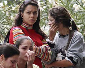 Relatives of passengers of Gol airlines flight 1907 from Manaus to Brasllia cry while they await news from the company and aviation authorities on the location and condition of the plane and its occupants, at the airport in Brasilla