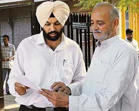 Fayyaz Ali Khan, Pakistan-based brother of late Sajida Begum, discusses a point with his lawyer outside the Chandigarh district courts