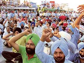 Veterinary pharmacists block traffic in front of the bus stand in Bathinda on Sunday.