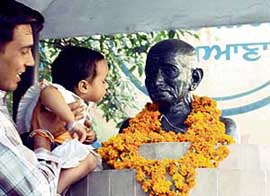 HAPPY BIRTHDAY BAPU: A child garlands a statue of the Father of the nation on Gandhi Jayanti in Ludhiana on Monday.