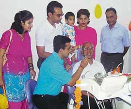 Dr Gagan Modgil examines a patient at a dental camp organised at Ahmedgarh on Monday.